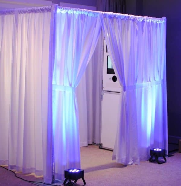 white enclosed photo booth perfect for a wedding